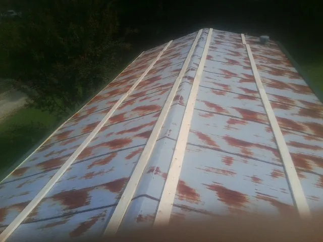 Rusted metal roof panels with new wood purlins before replacement — Storm Damage Roof Repair in Airville by Roofing Brothers